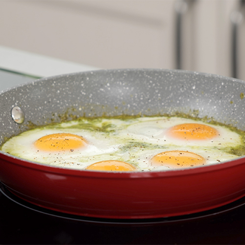 Pesto fried eggs in a pan