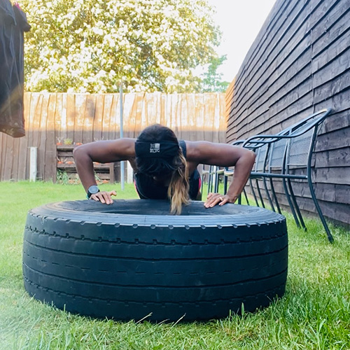 Samantha doing push-ups on a tyre-summer activity ideas-slimming world blog