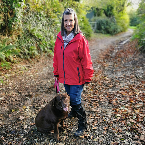 Slimming World member Lisa walking her dog in the woods