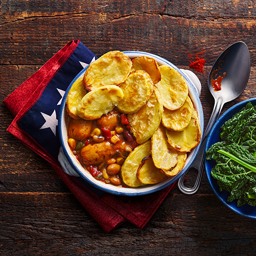 Slimming World cowboy hotpot in white bowl on wooden table with American flag napkin underneath