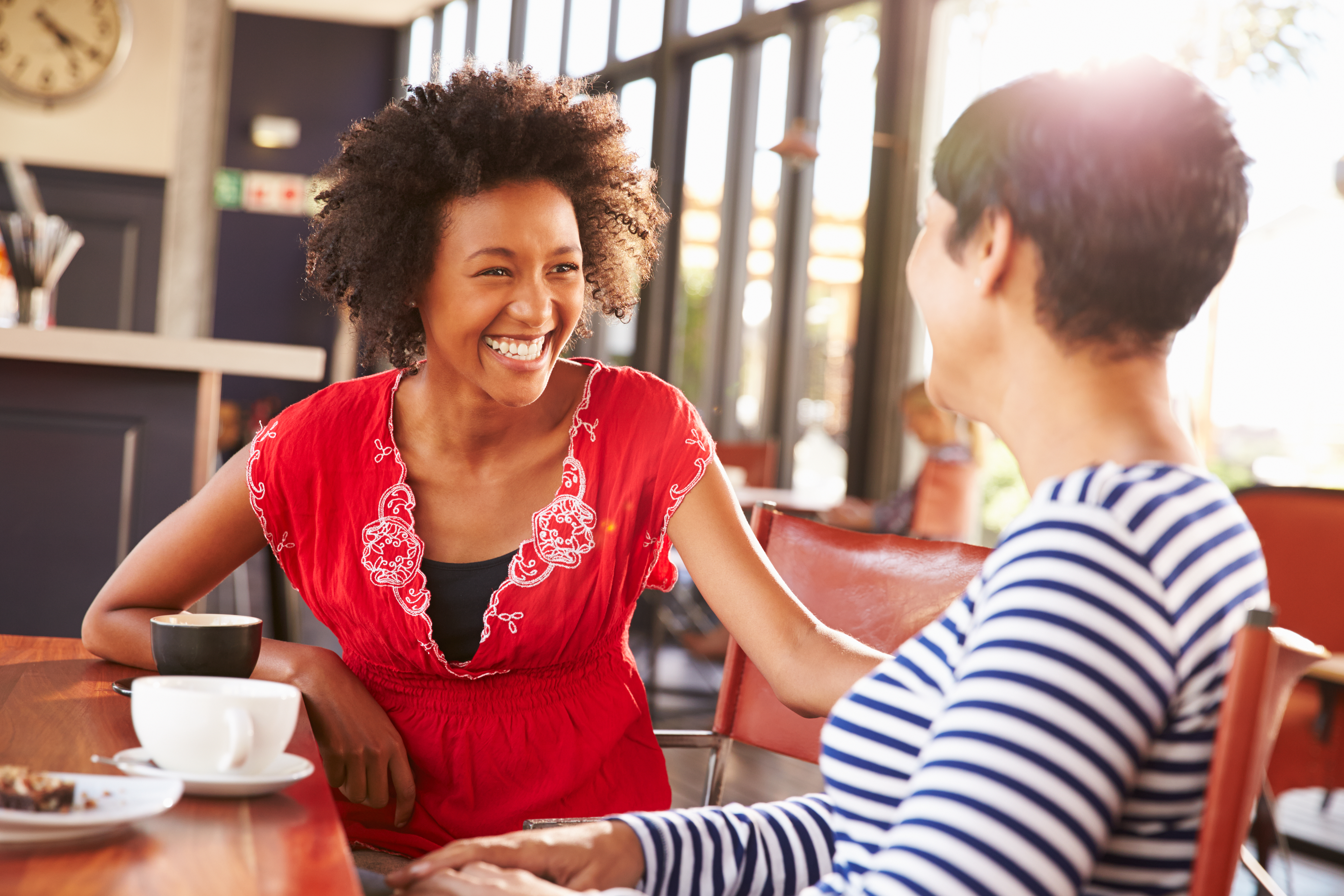 Two women chatting and enjoying coffee