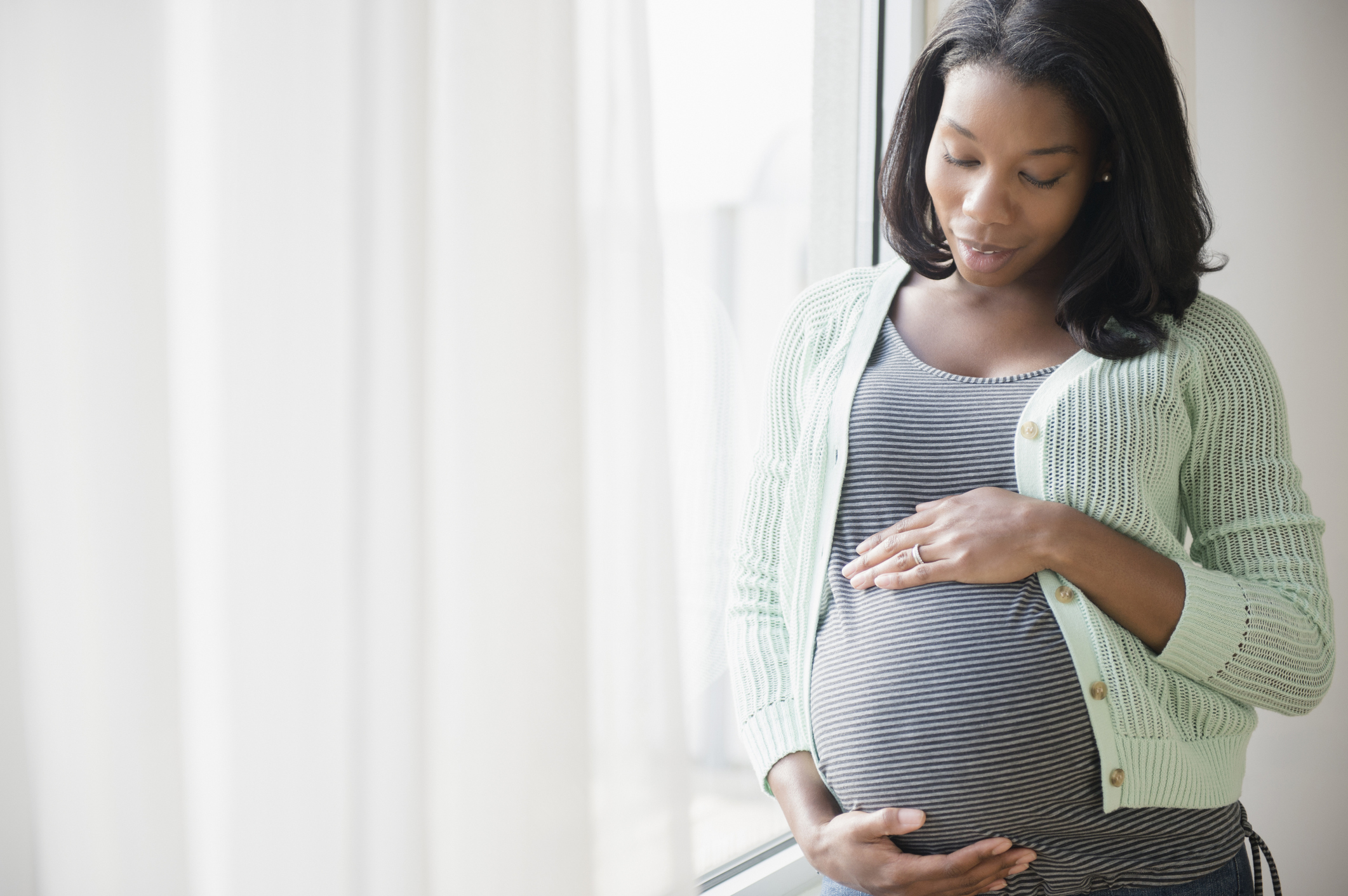 Pregnant lady holding her baby bump