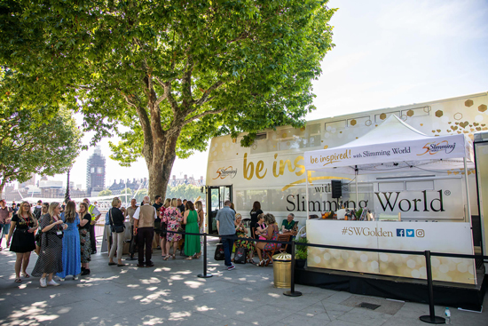 Image shows Slimming World's golden bus on the Slimming World golden bus tour