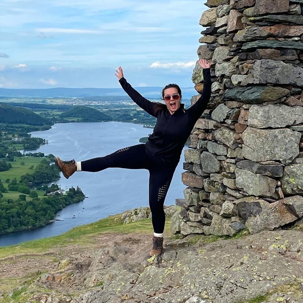 Slimming World member Chloe poses in front of a lake during a hike