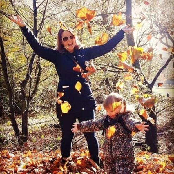 Slimming World member and daughter, playing in the autumn leaves