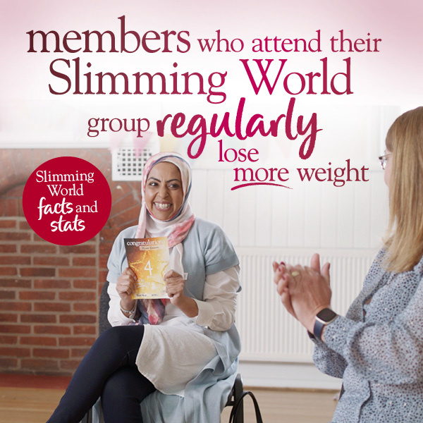 Slimming World member in group holding her weight loss certificate