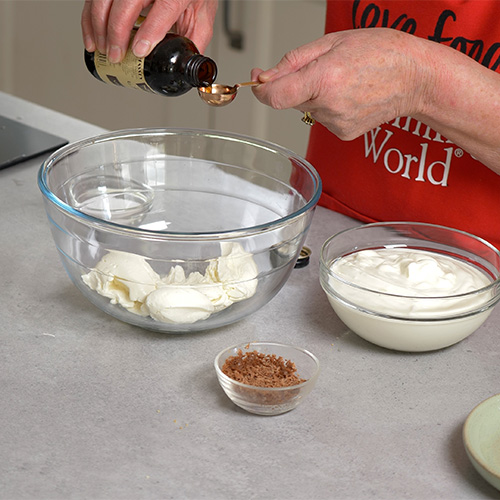 Slimming World chef adding vanilla to cheesecake mixture