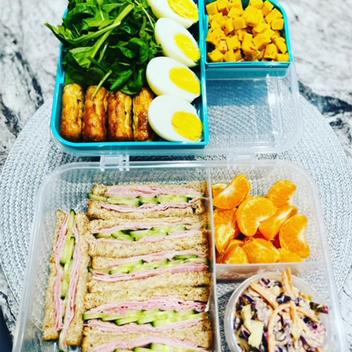 Slimming World packed lunch with sandwiches, fruit, coleslaw, egg and salad