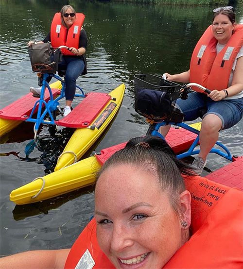 Slimming World members riding boyancy bikes