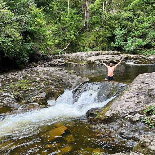 Slimming World member Aaron swimming in a waterfall