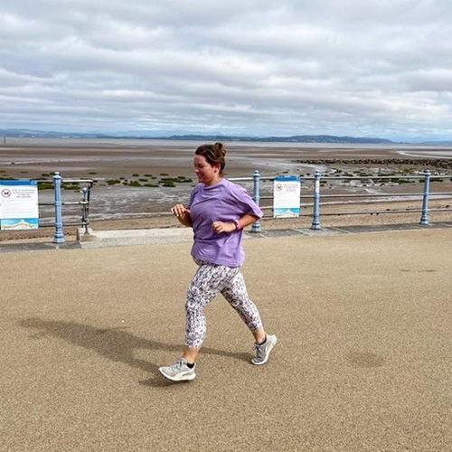 Slimming World member Lisa running at the seaside