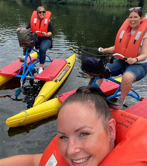 Lynsey sitting on a buoyancy bike in the Norfolk Broads