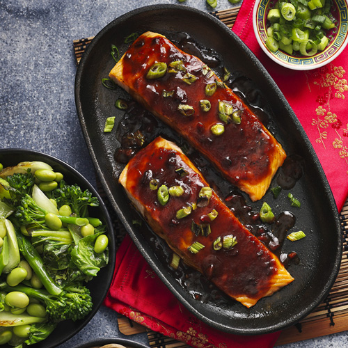 Slimming World teriyaki salmon on a black pan on a grey background