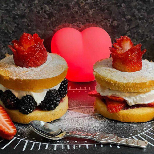 Two sponge cakes filled with cream and strawberries and blackberries