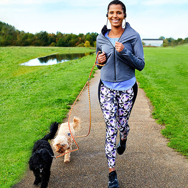 Slimming World member Ashli running with her two dogs