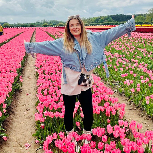 Kirsty in a field of pink tulips