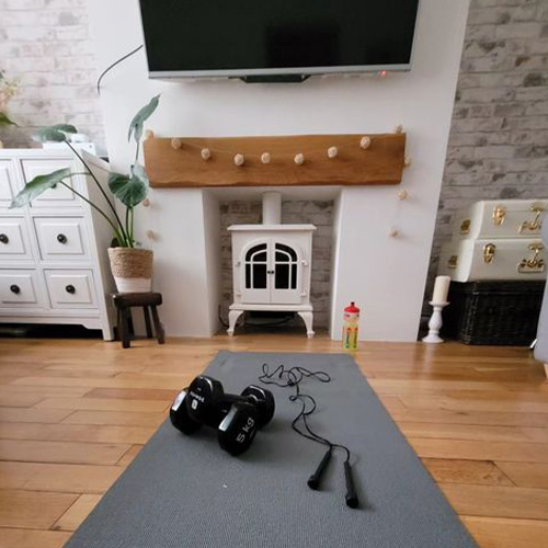 Zena's weights, skipping rope and exercise mat on her living room floor