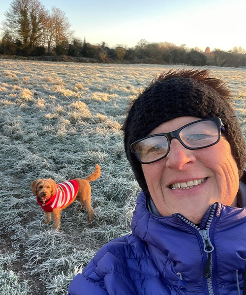 Slimming World member Sara walking her dog across a frost-covered field