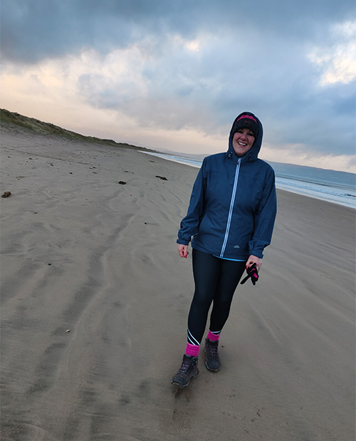 Slimming World member Kerry walking on the beach