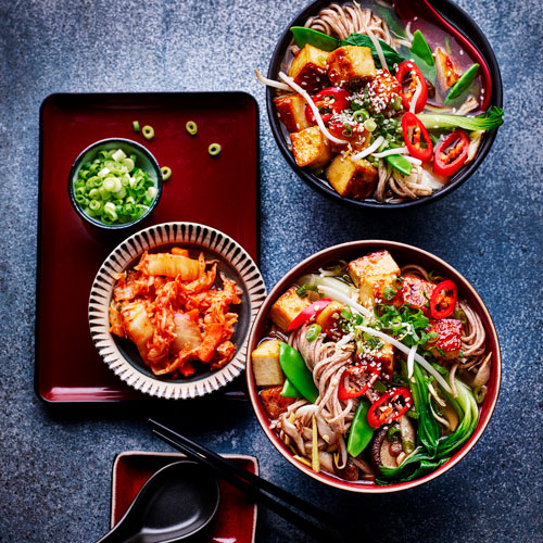 Slimming World chilli ramen bowl with kimchi and spring onions on the side