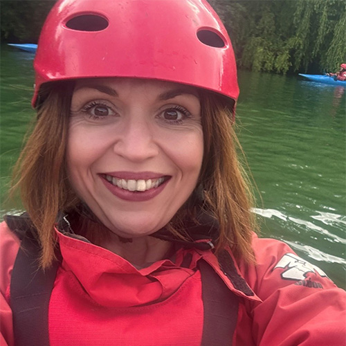 Slimming World Consultant Kelly taking a selfie in red helmet and waterproof jacket