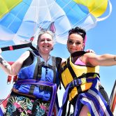 Slimming World member Becs posing next to her niece with a colourful parachute behind them – one of Slimming World's 11 summer activity ideas