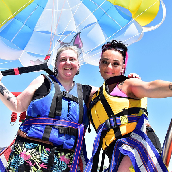 Slimming World member Becs posing next to her niece with a colourful parachute behind them – one of Slimming World's 11 summer activity ideas
